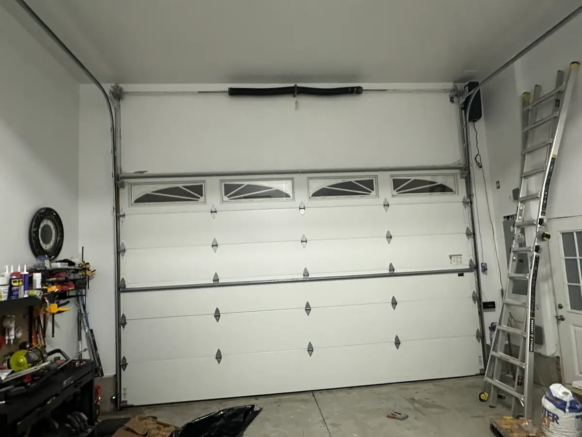 Finished garage door installation after panel replacement
